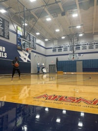 a man is playing basketball in a gym